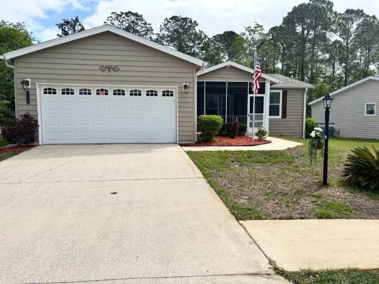 Suburban house with garage and American flag.
